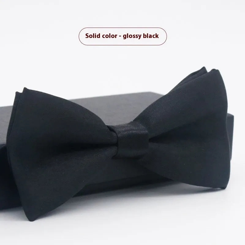 A solid colour pre-tied bow tie with an adjustable neck strap, shown in a classic flat head shape.