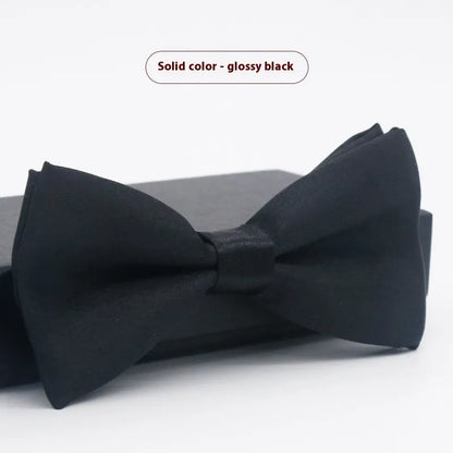 A solid colour pre-tied bow tie with an adjustable neck strap, shown in a classic flat head shape.