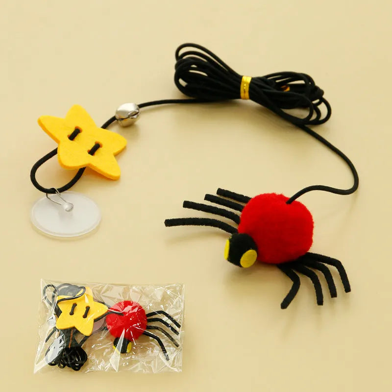 Red hanging door cat toy with elastic rope, feathers and spider-shaped bell mounted on door frame