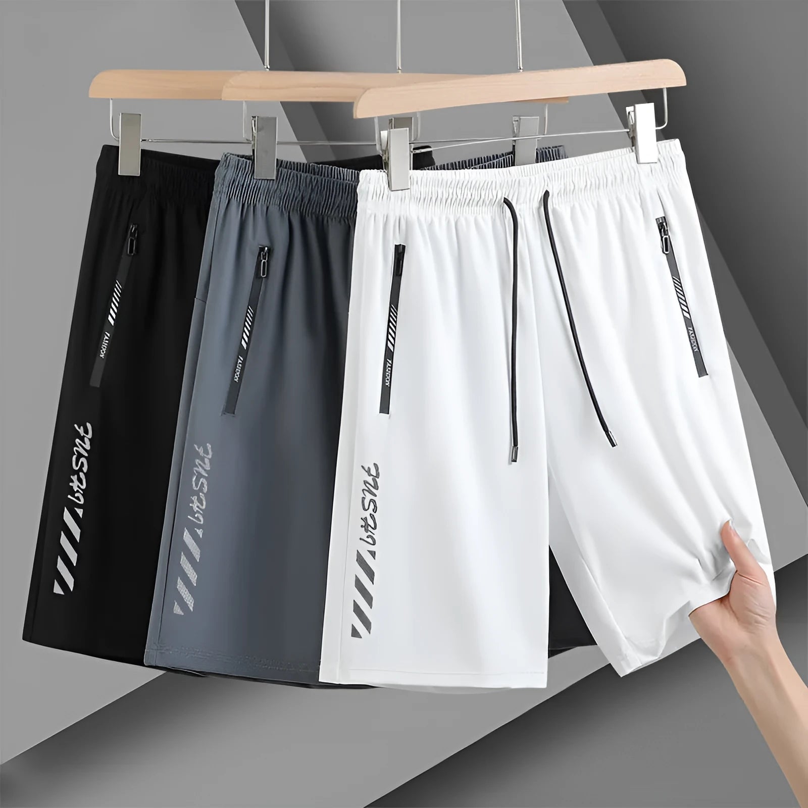 Man wearing black loose-fit quick-dry nylon sports shorts with an elastic waistband.