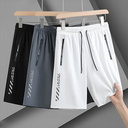 Man wearing black loose-fit quick-dry nylon sports shorts with an elastic waistband.