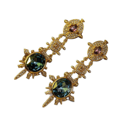 A pair of gold-coloured geometric stud earrings with round details and a retro style.