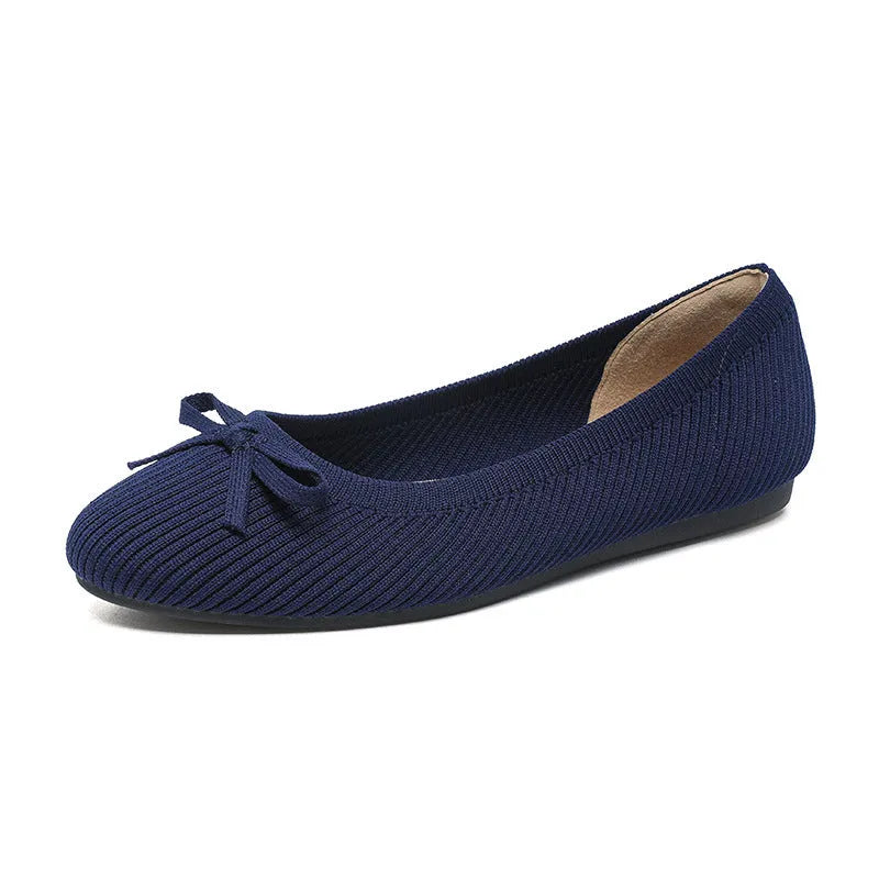 Women's round toe flat pumps with bow detail in butterfly colours showing fabric upper and shallow mouth opening