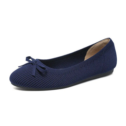 Women's round toe flat pumps with bow detail in butterfly colours showing fabric upper and shallow mouth opening