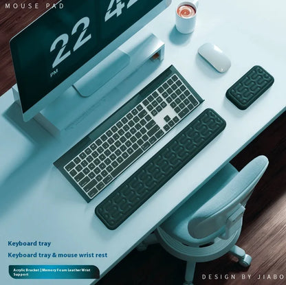 Double-sided black and grey keyboard mouse pad with wrist strap and hand pillow on a desk.