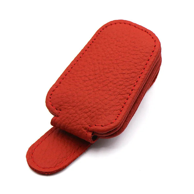 Car sunglasses holder clip with PU leather case attached to a sun visor.