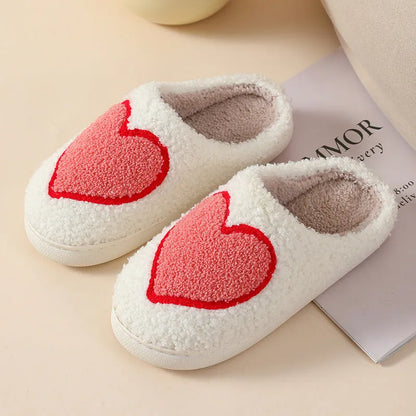 Adult women's plush home slipper in a cartoon love design with a round toe and non-slip PVC sole.