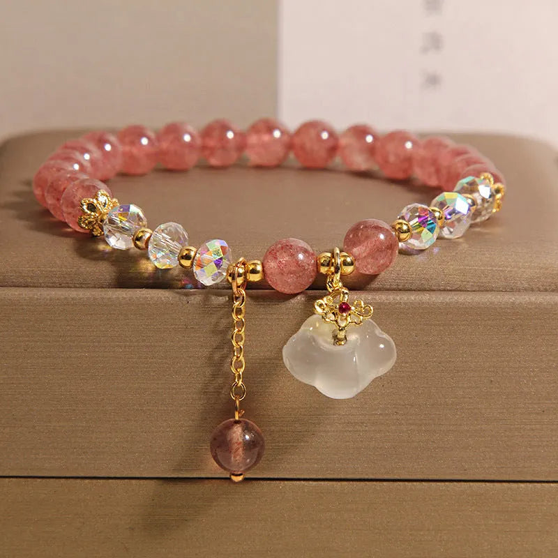 Women's strawberry quartz and white agate crystal bracelet with auspicious cloud charms on elasticated cord
