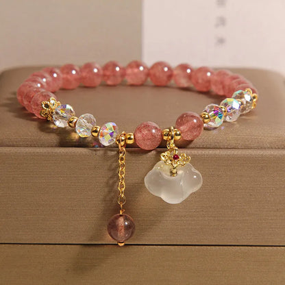 Women's strawberry quartz and white agate crystal bracelet with auspicious cloud charms on elasticated cord