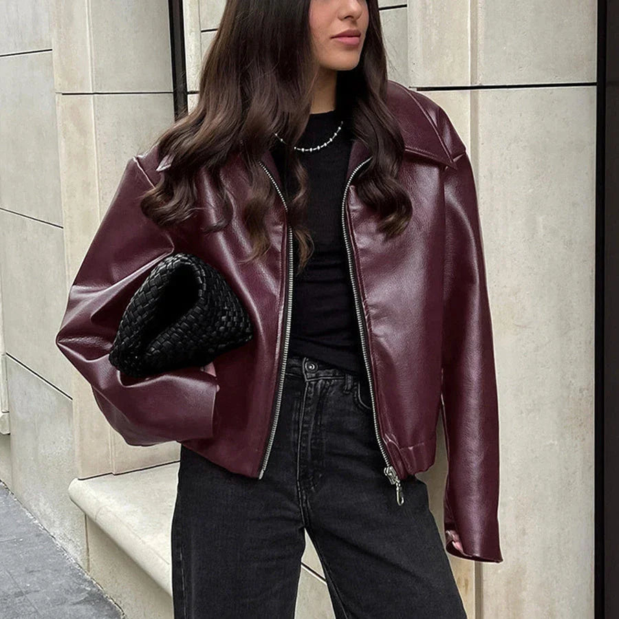 A stylish faux leather jacket with a zipper closure and lapel, available in burgundy and black colors.