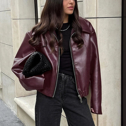 A stylish faux leather jacket with a zipper closure and lapel, available in burgundy and black colors.