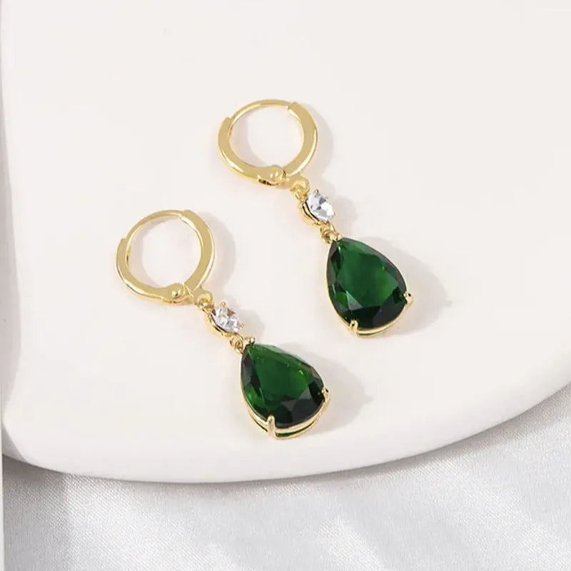 A pair of emerald green geometric teardrop drop earrings made from alloy