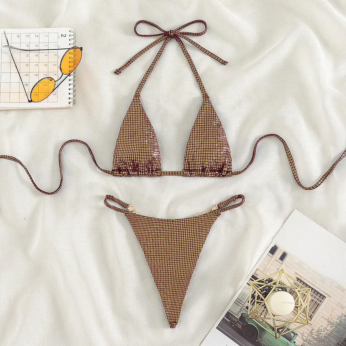 Women's solid colour blue T-back split bikini top and briefs set on a neutral background.