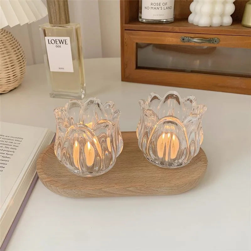Transparent glass tulip candle holder with classic tumbler base on table