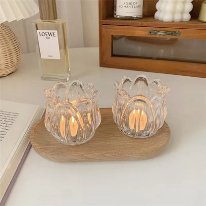 Transparent glass tulip candle holder with classic tumbler base on table