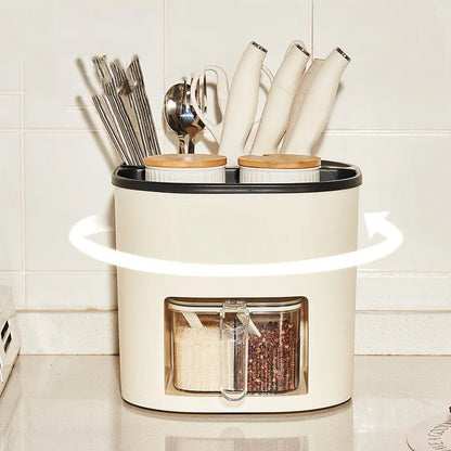 White rotating plastic kitchen storage bucket and a separate white spice box with four compartments on a countertop.