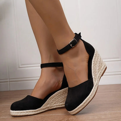 Women's Roman-style wedge sandals in suede with buckle fastening, shown in apricot and black colours