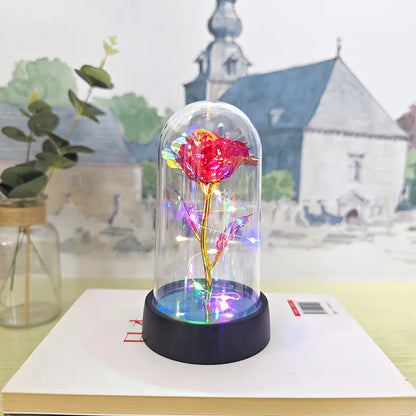 Glass cover small night lamp with plastic flowers, 15cm height, black base, showing colour light options