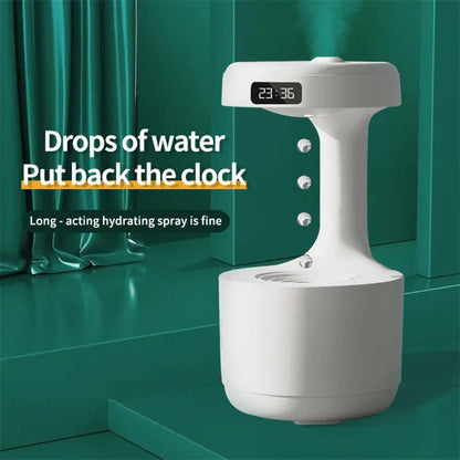 White columnar anti-gravity humidifier with water droplet backflow and LED clock display on a desk.