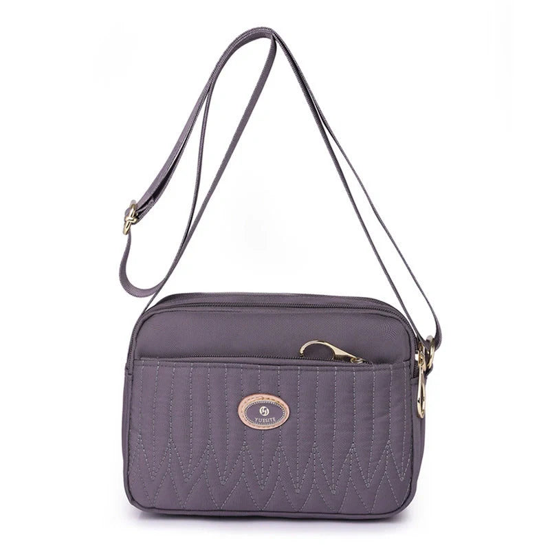 Compact nylon messenger bag for women in various colours with adjustable strap