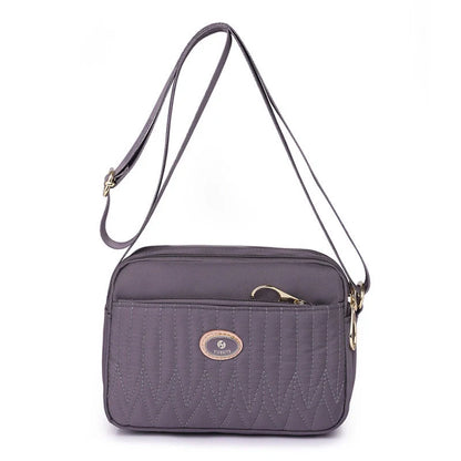 Compact nylon messenger bag for women in various colours with adjustable strap