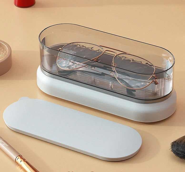 Compact ultrasonic cleaning machine for watches and small items, white colour, on a table