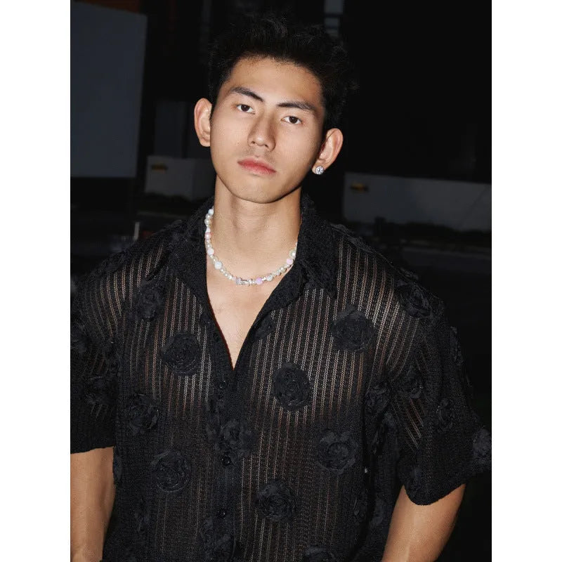 Men's loose fit floral print short sleeve shirt in black with a wool lining, shown on a mannequin.