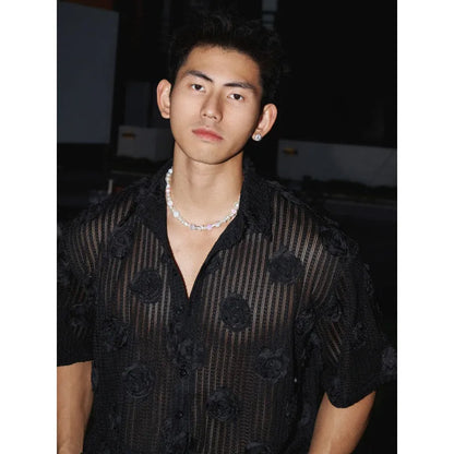 Men's loose fit floral print short sleeve shirt in black with a wool lining, shown on a mannequin.