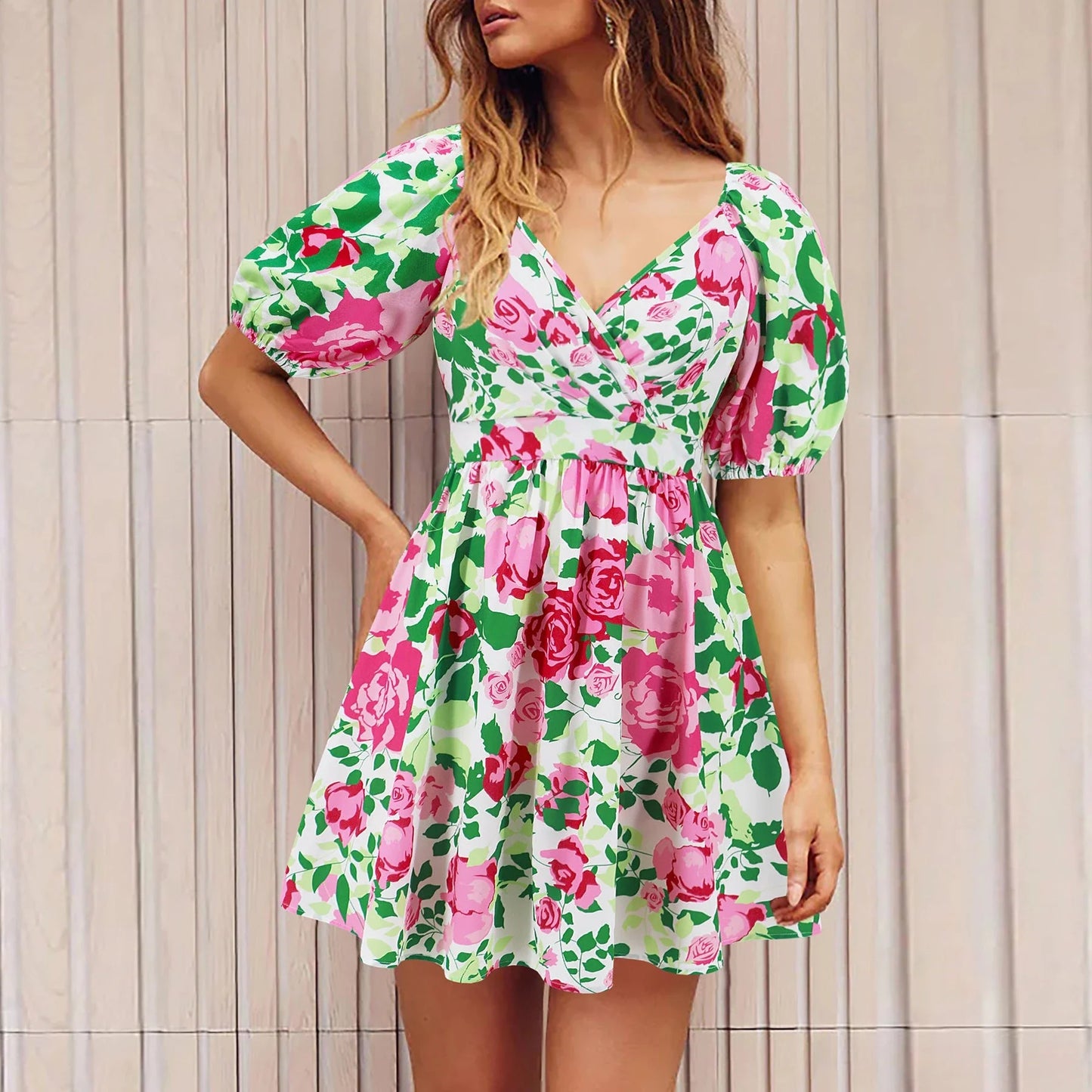 Stylish floral mini dress with V-neck and lantern sleeves, perfect for summer vacations and beach outings