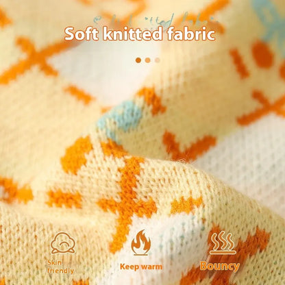 Orange cherry diamond pattern cat sweater shown on feline model with size label