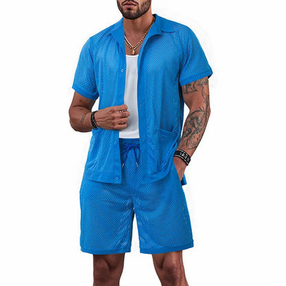 Light blue see-through beach shorts suit with matching cardigan on a summer background.