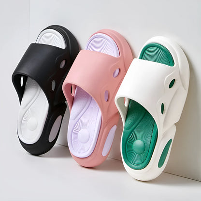 Pair of two-tone thick-soled EVA slippers with a leather lining, shown in pink and purple.