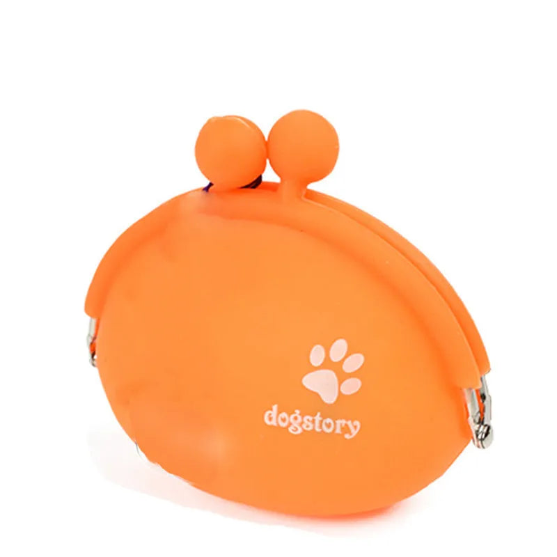 Yellow silicone dog training treat pouch with hook and loop closure, shown on a waistband.