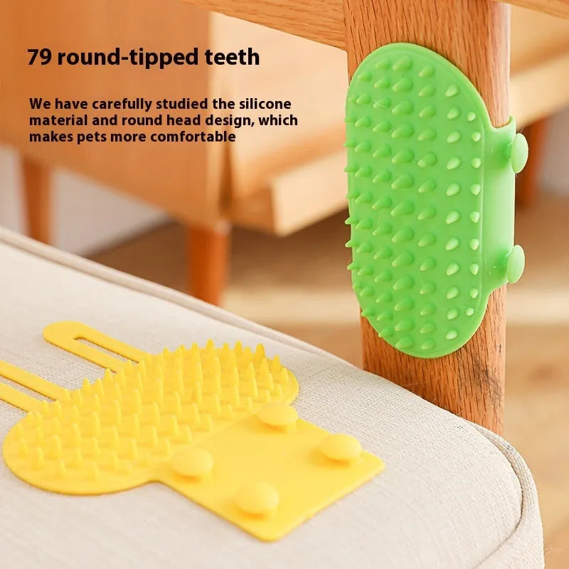 Silicone cat grooming comb with adjustable strap mounted on a table leg, shown in green.