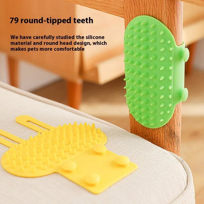 Silicone cat grooming comb with adjustable strap mounted on a table leg, shown in green.