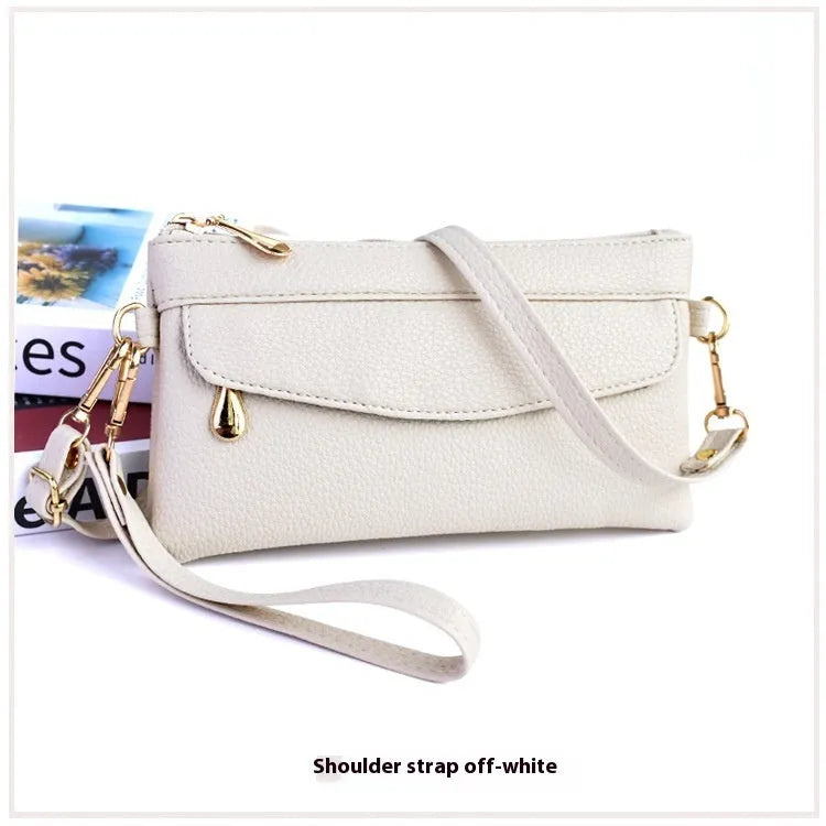 Soft surface square PU crossbody bag and clutch with internal zipper pocket in various colours.