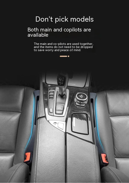 Black car seat gap storage box organiser with compartments and carrying handle between vehicle seats