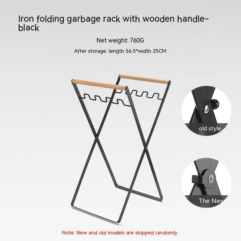 Black outdoor folding trash rack with wooden handle, holding a waste bag.