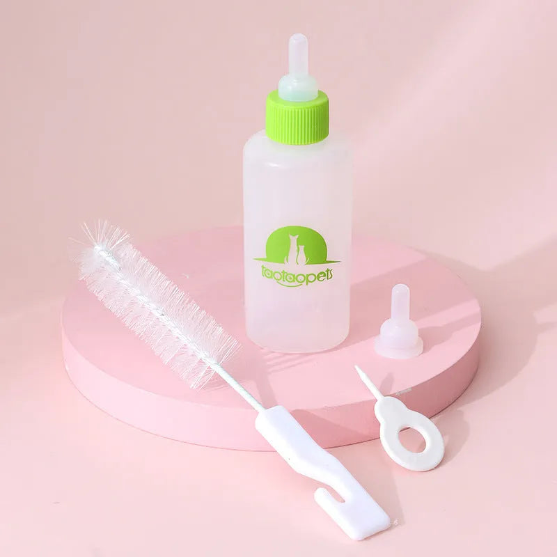 Set of four coloured pet milk bottles with silicone teats and a cleaning brush for small animals.