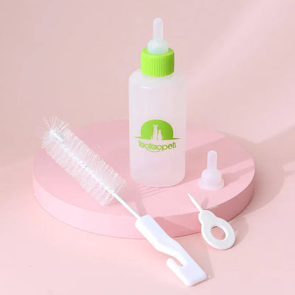 Set of four coloured pet milk bottles with silicone teats and a cleaning brush for small animals.