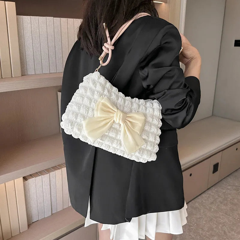 Women's black canvas single shoulder handbag with a sandwich pocket and horizontal square shape.