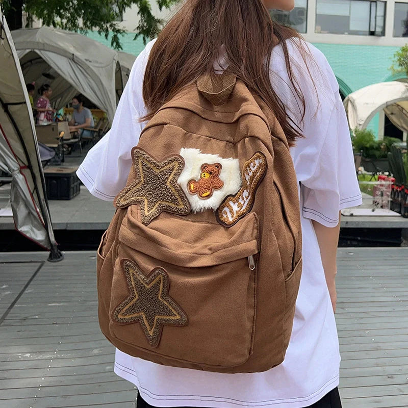Brown canvas backpack with geometric patterns, ideal for female college students