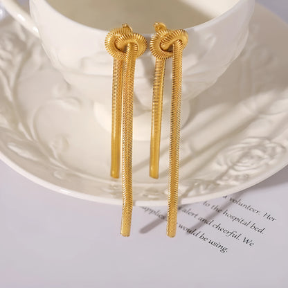 Gold electroplated titanium steel necklace with snake chain and knotted tassel pendant, shown with matching earrings.