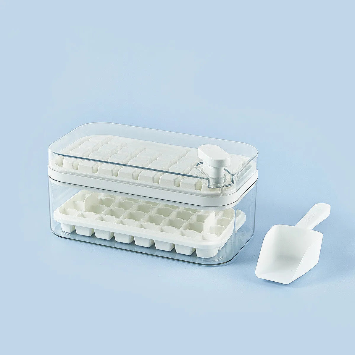 Green one-button press ice mould box with storage lid and ice shovel on kitchen counter