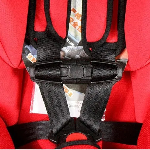 Black nylon chest buckle clip for a child car seat harness with a visible lock button.
