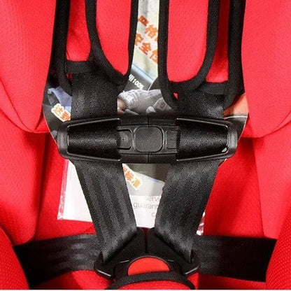 Black nylon chest buckle clip for a child car seat harness with a visible lock button.