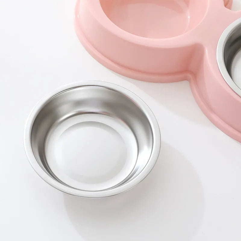 Stainless steel pet bowl with frog design and two compartments for food and water.