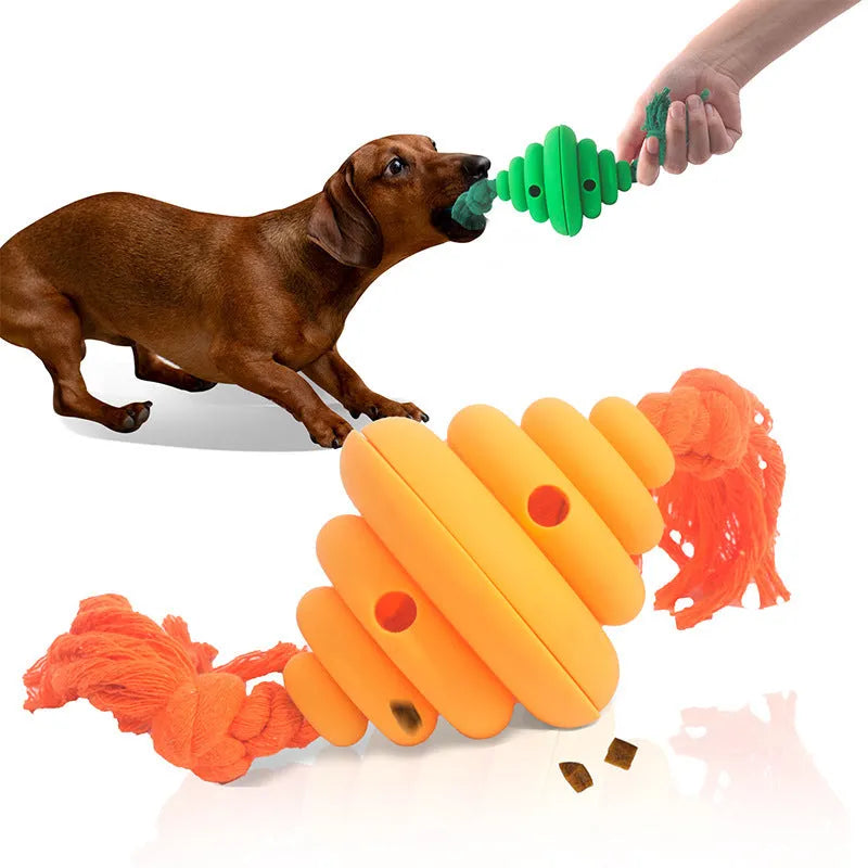 Green and yellow dog ball with attached knotted rope chew and feeder toy on grass.