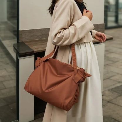 Women's black waterproof Oxford cloth crossbody shoulder bag with expansion function.