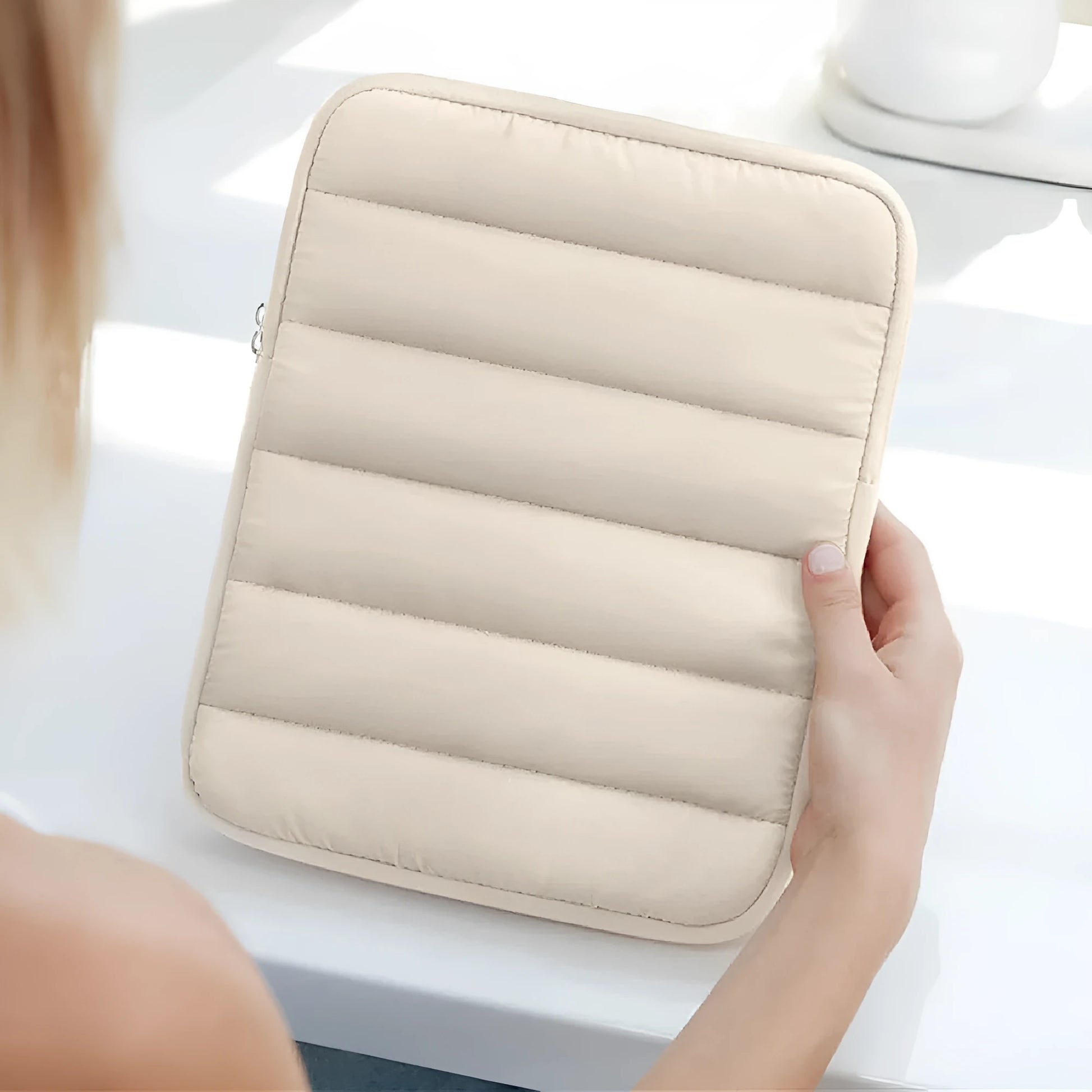 Fluffy air feeling puff bag laptop sleeve in black, shown with elastic sides stretching.